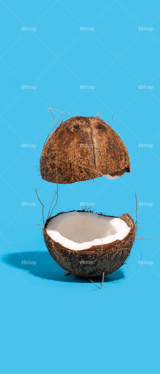 Coconut split on half. 21:9 aspect ratio. Phone wallpaper