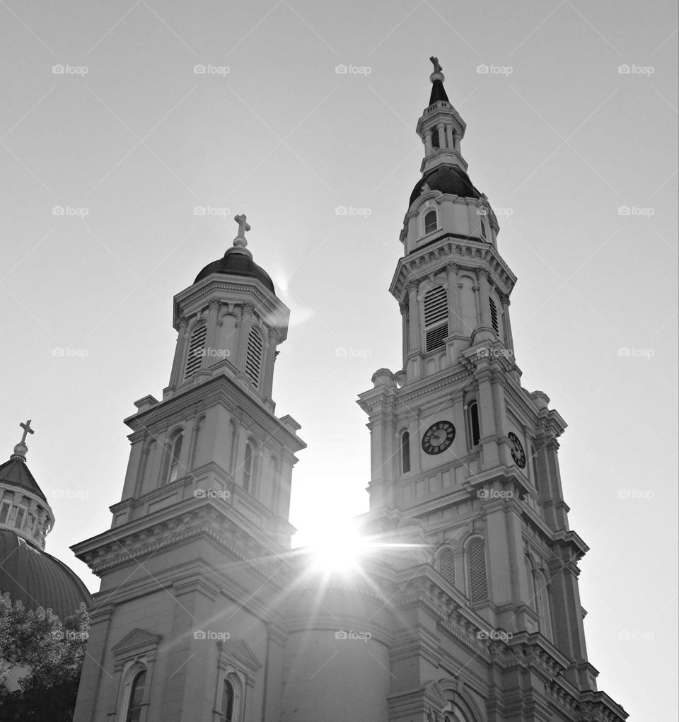 black and white sunrise over the Twin Towers of a church building