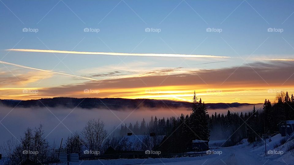 Beautiful sunset above the village's dense fog!