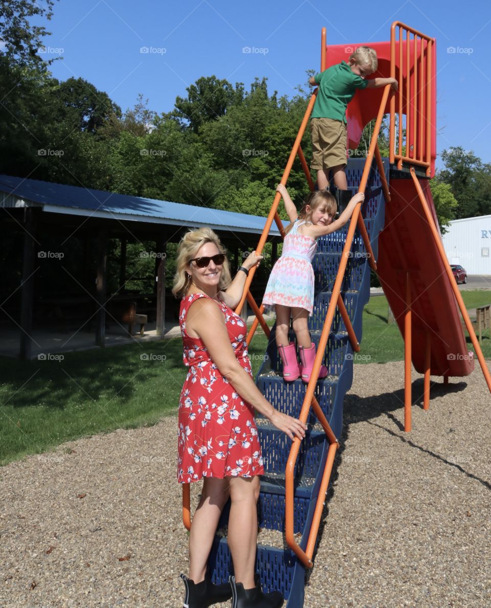 Summer memories, family going up a sliding board