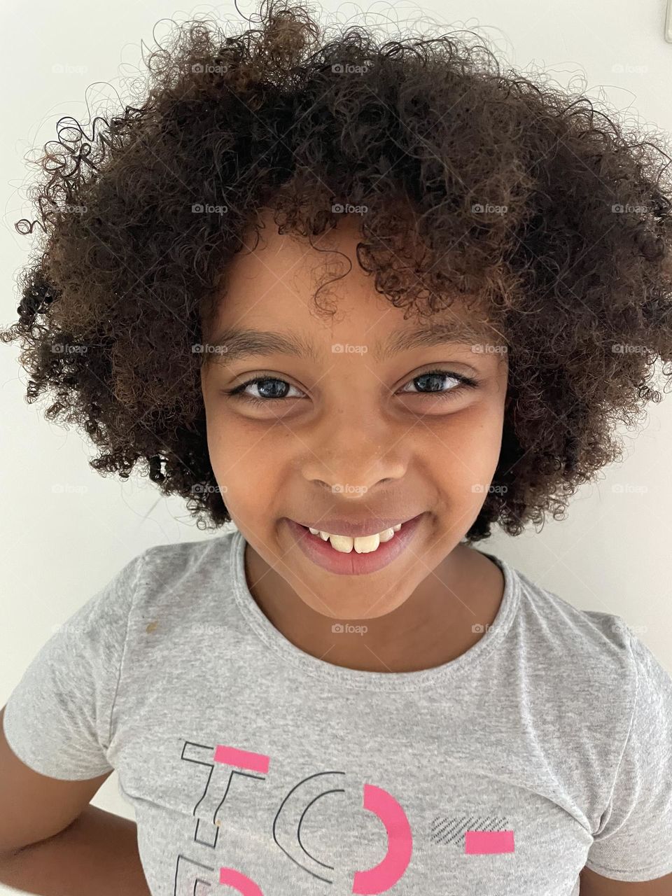 Girl of mixed race with curly hair - afro