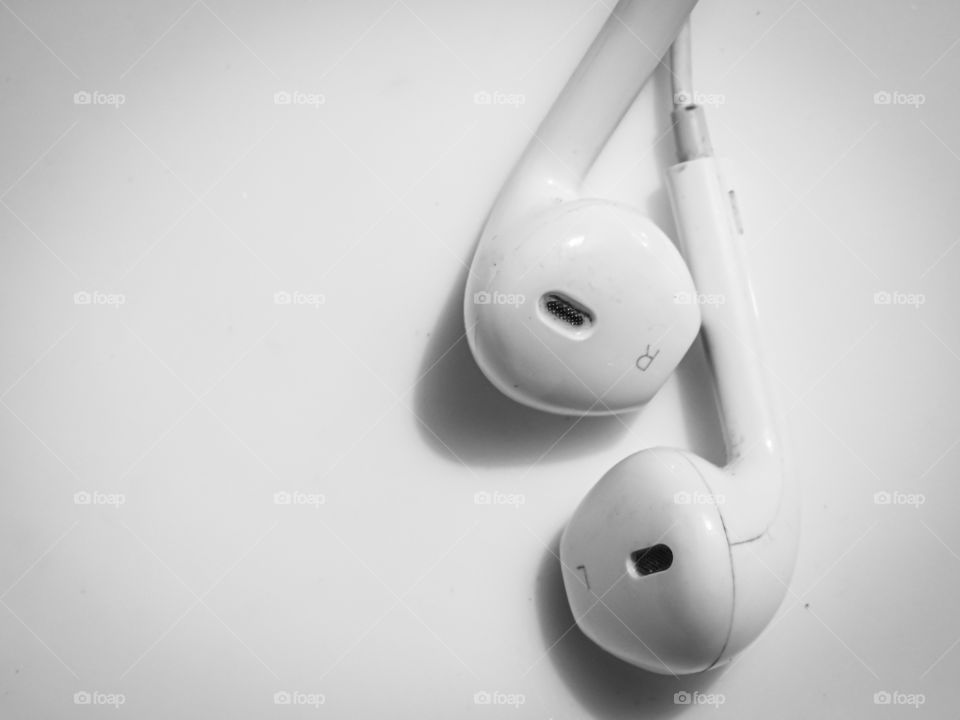 Earphone - My favorite gadget. It is white in colour with white background used for smart devices. listening songs.