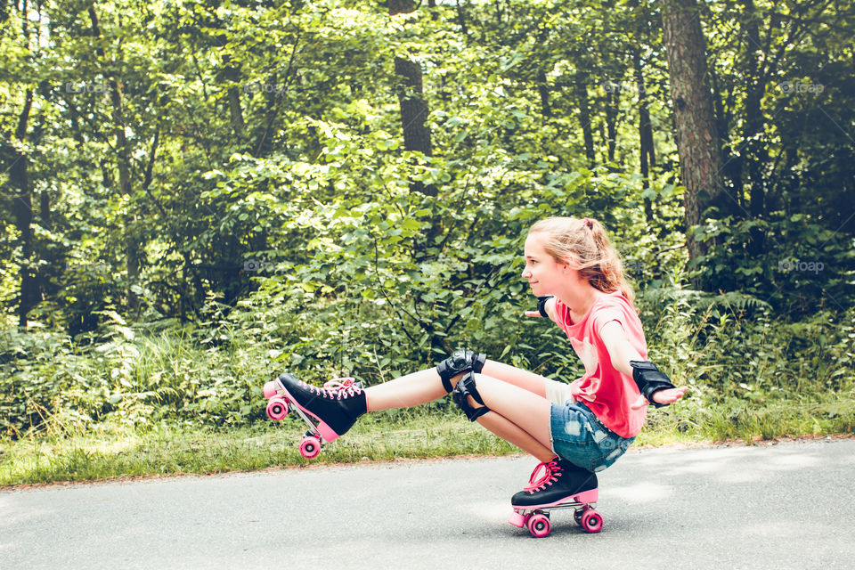 Little girl skating on street