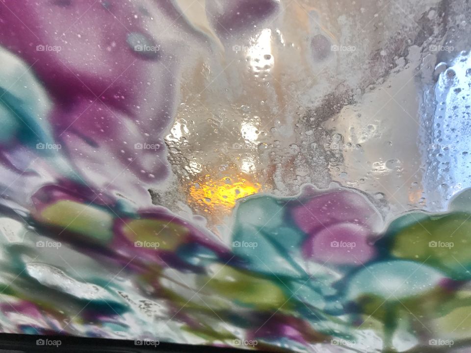 Multicolored soap suds at car wash