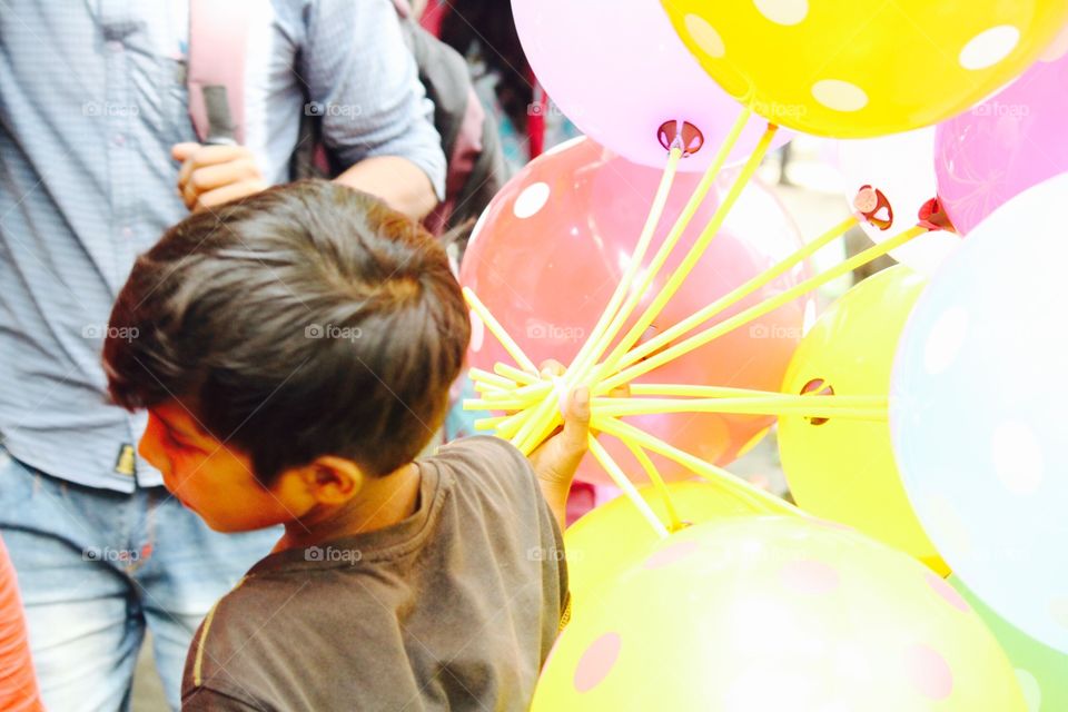Child selling balloons 