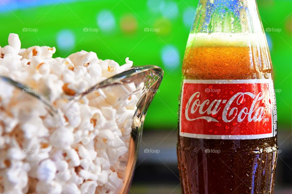 Coca Cola and popcorn with football