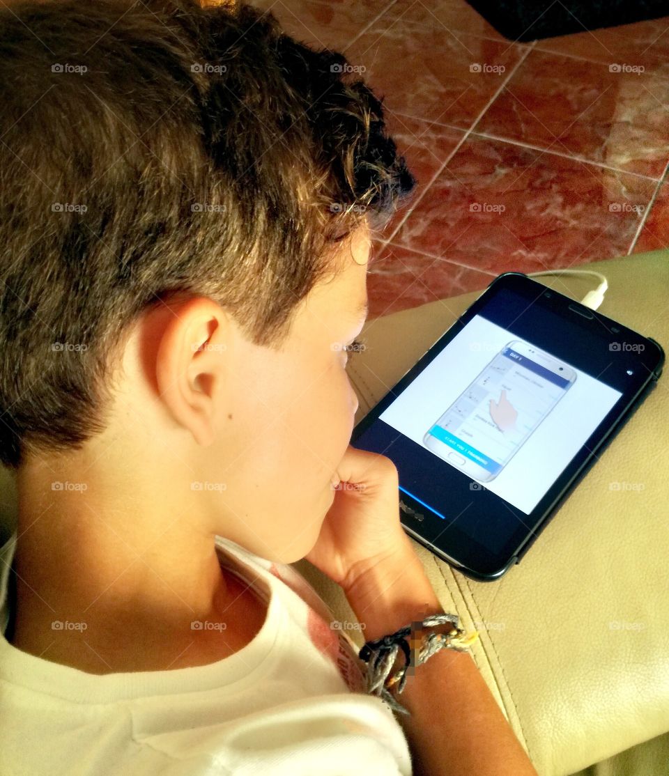 Child looking to his tablet