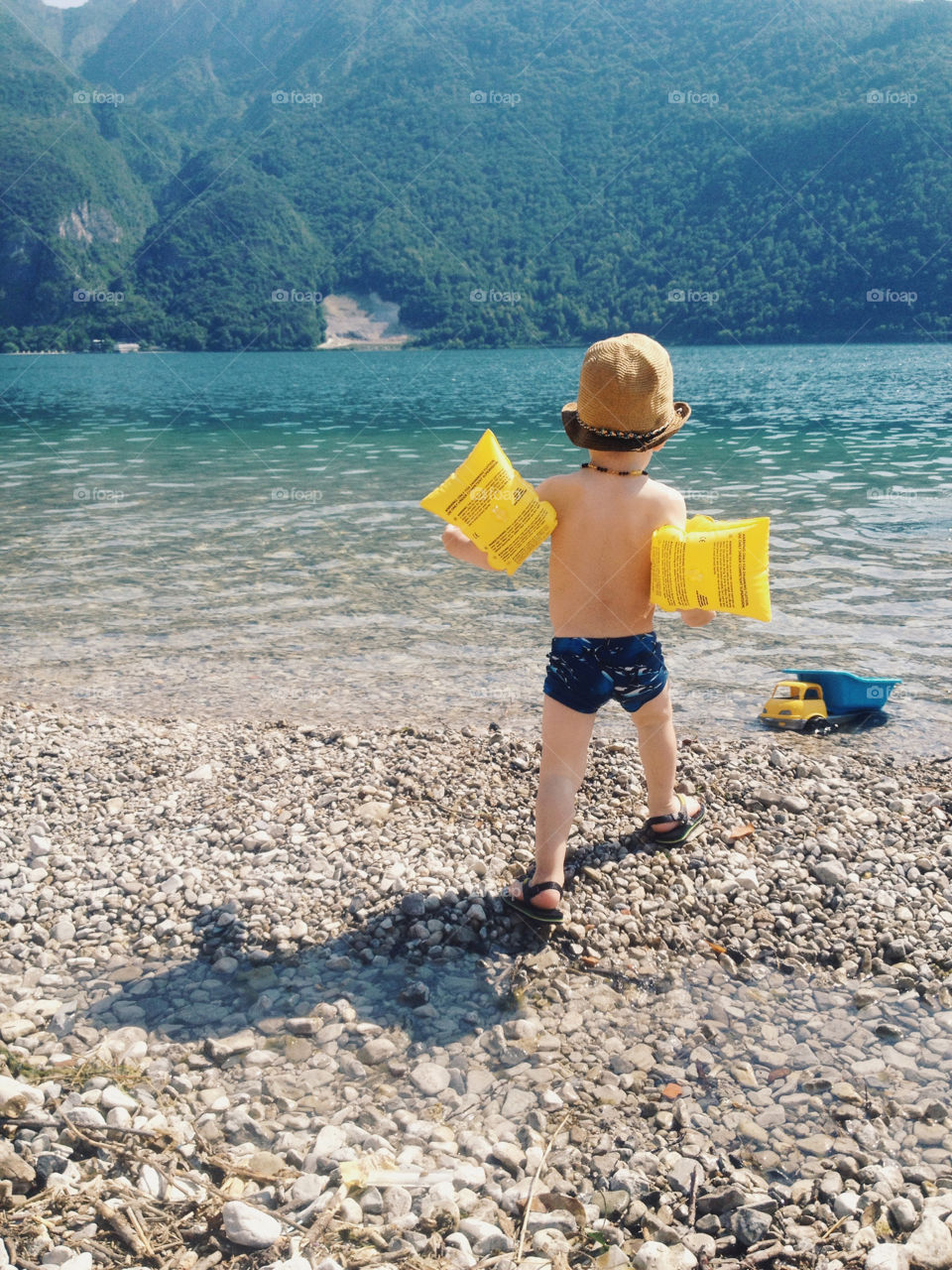A boy enjoying the sun and water at lake Como in Italy