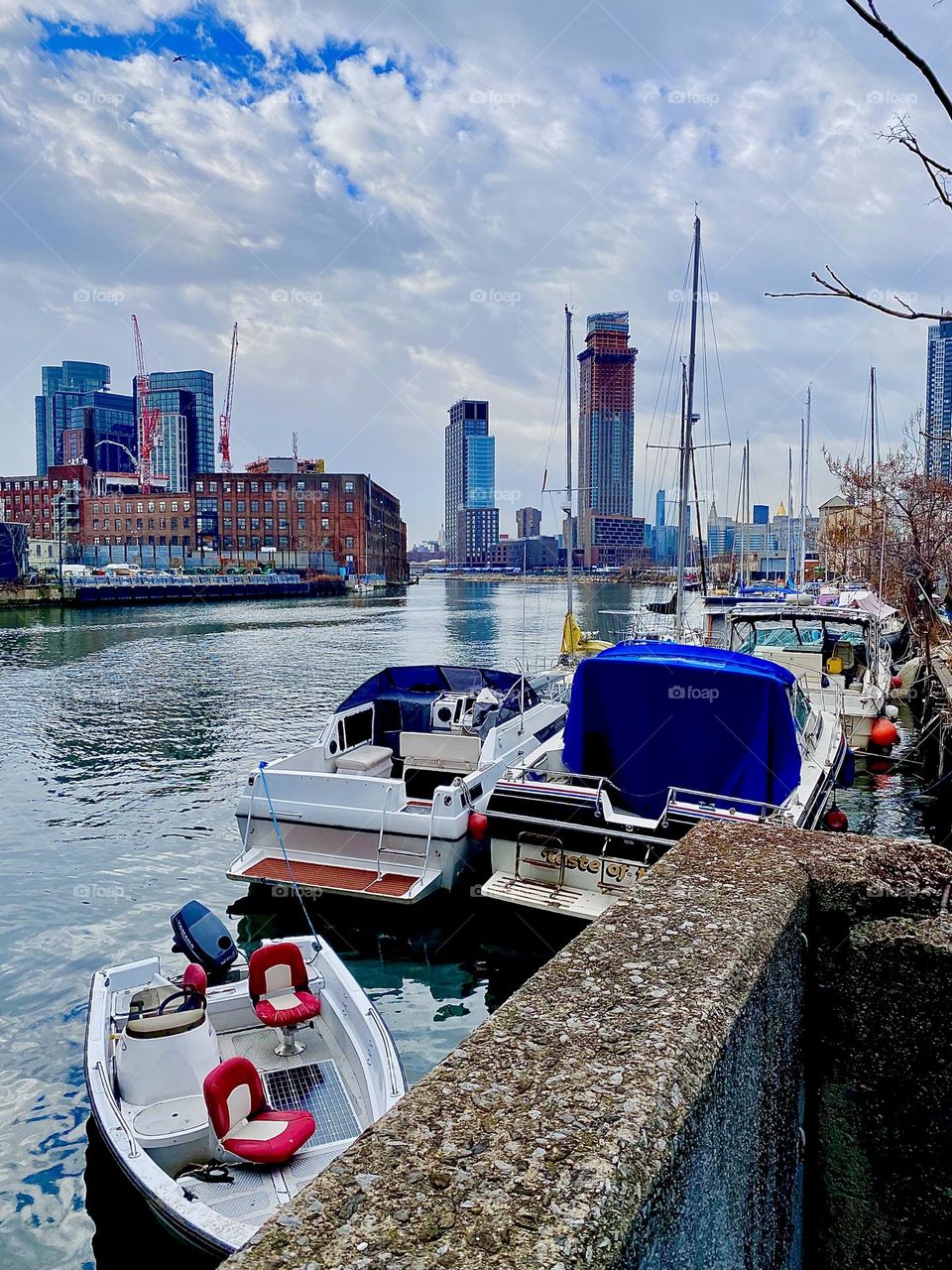 A panoramic view of Newtown Creek in Long Island City, Queens, NY with boats in the waters of the East River photographed on an overcast afternoon in December 2021. Hypnotic Productions