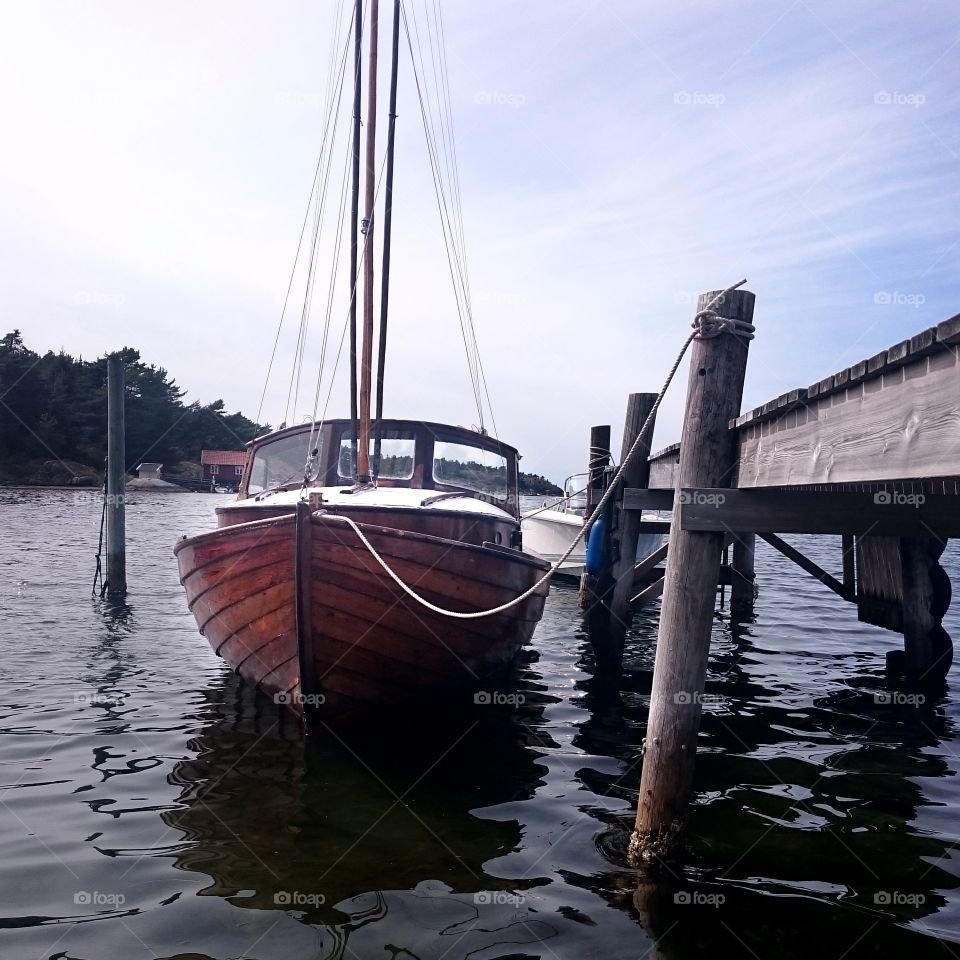 Wooden boat by pier. Wooden boat by pier in low perspective