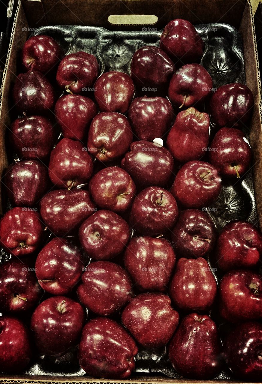 Dark red apples at market
