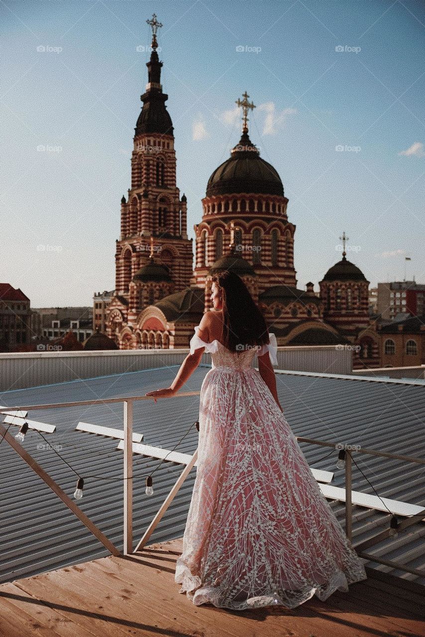 Brunette girl stay in rose dress