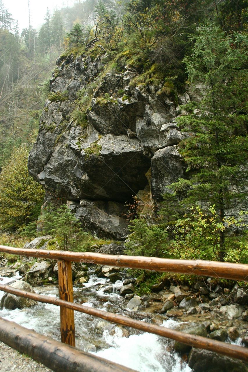 Beautiful rock and bridge over stream in the mountains