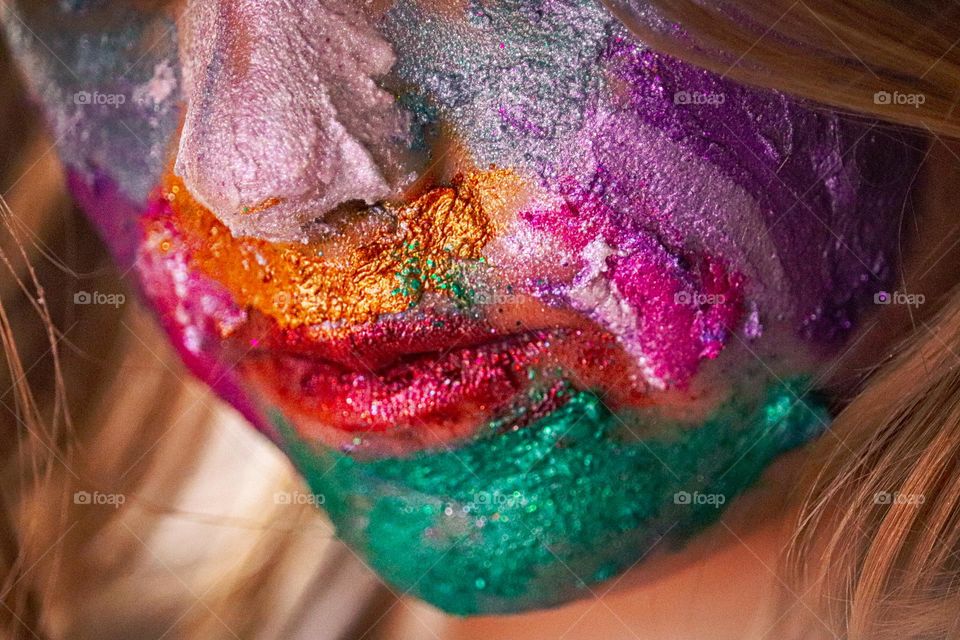 A child wearing glitter makeup