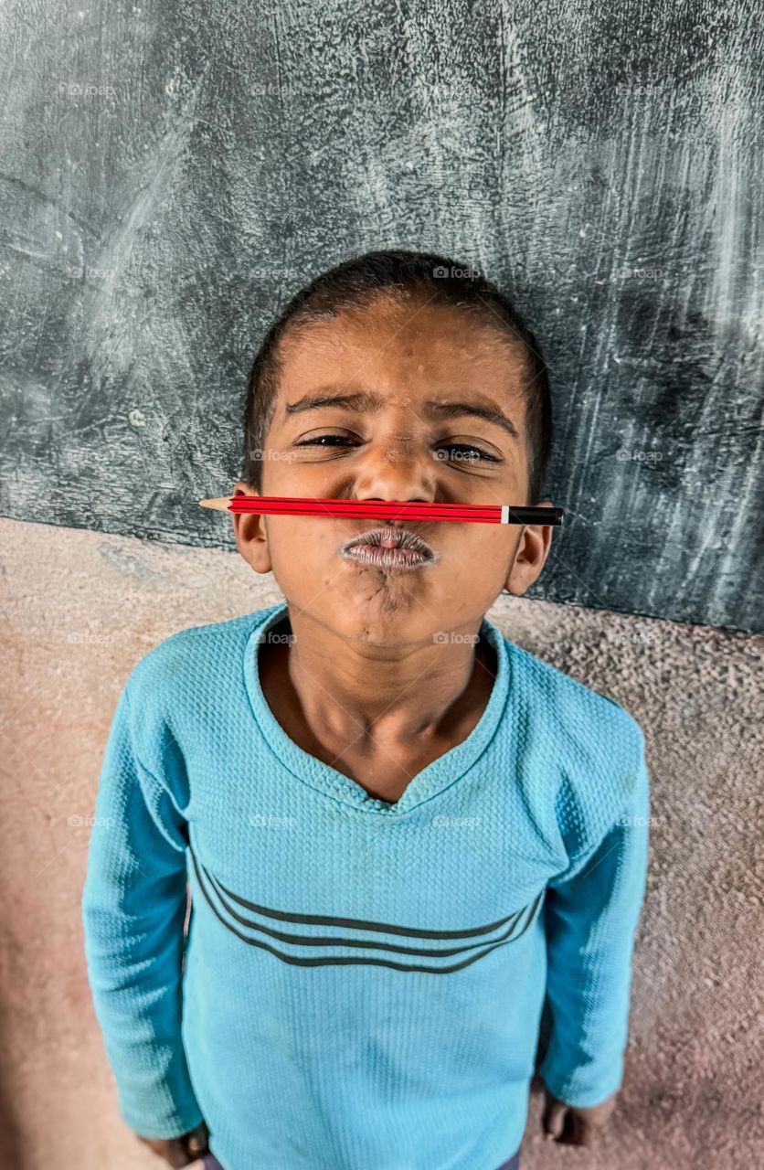 What is that pencil doing there?Funny portrait of a kid.