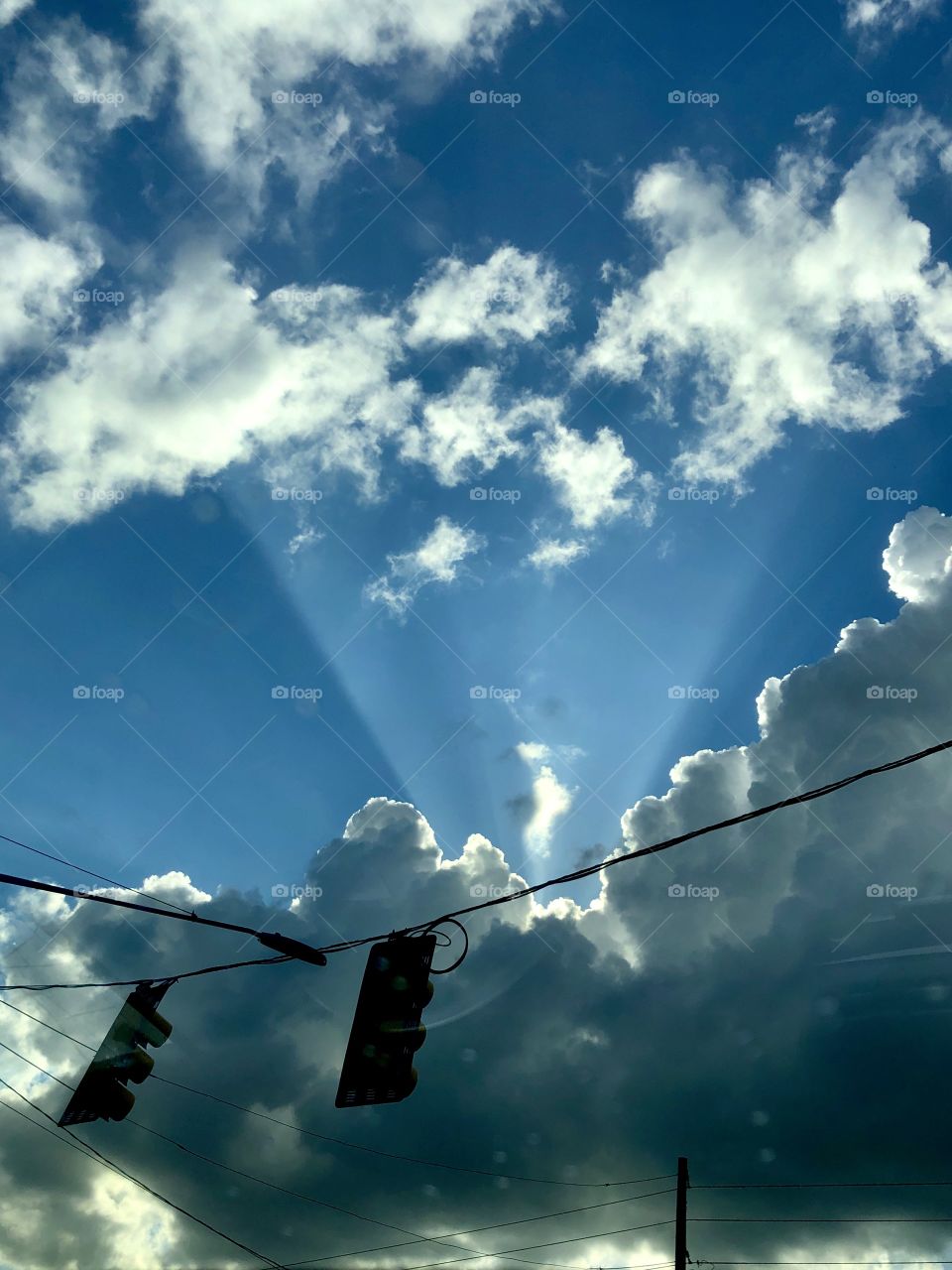 View through car sunroof driving into summer thunderstorm 