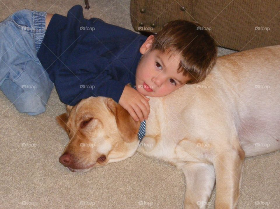 Boy using dog as pillow