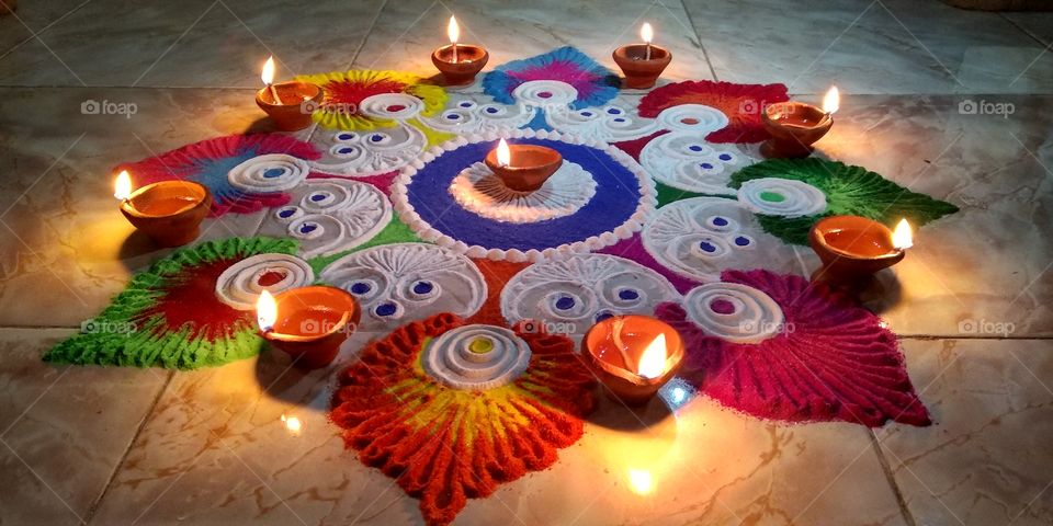 Beautiful Rangoli made on the occasion of Diwali ( Deepawali ) / The festival of Lights, decorations, joy and happiness / The Indian Festival / Culture and Traditions / Colorful Street Drawing / Lamps / Gleam / Happy Diwali