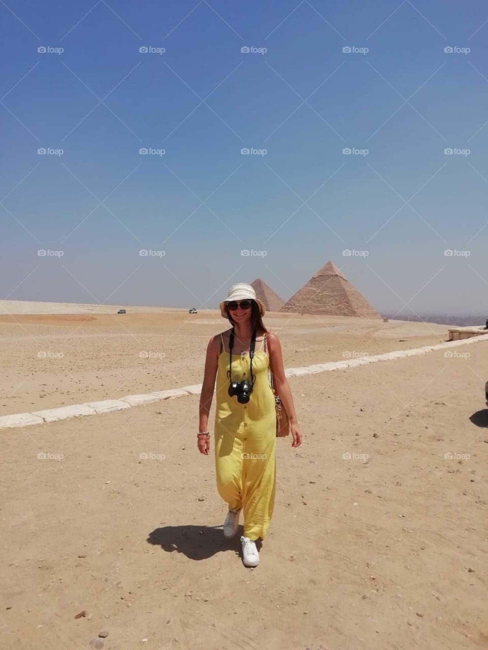 she's walking around the panorama view pyramids very attractive photo really very beautiful.