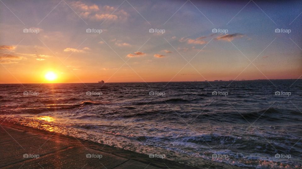Orange sunrise on the sea horizon