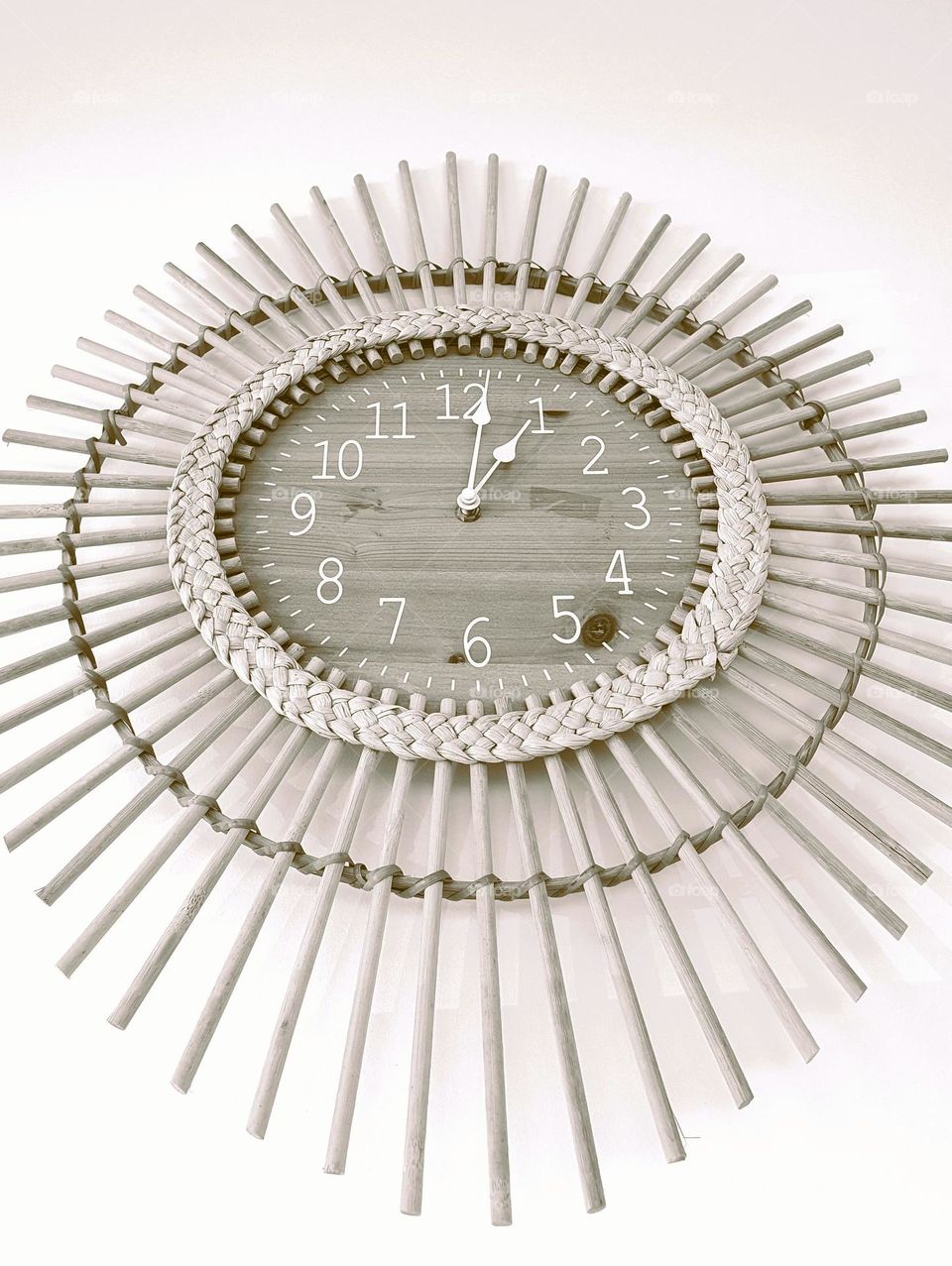 Sepia close-up shot of a vintage wicker framed wooden clock