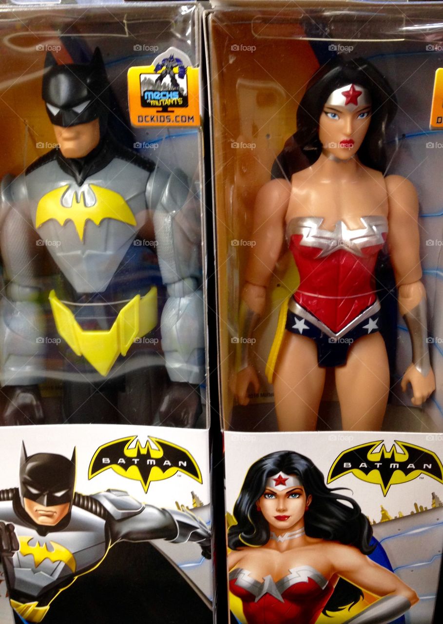 Batman & Wonder woman action figures in a shelf