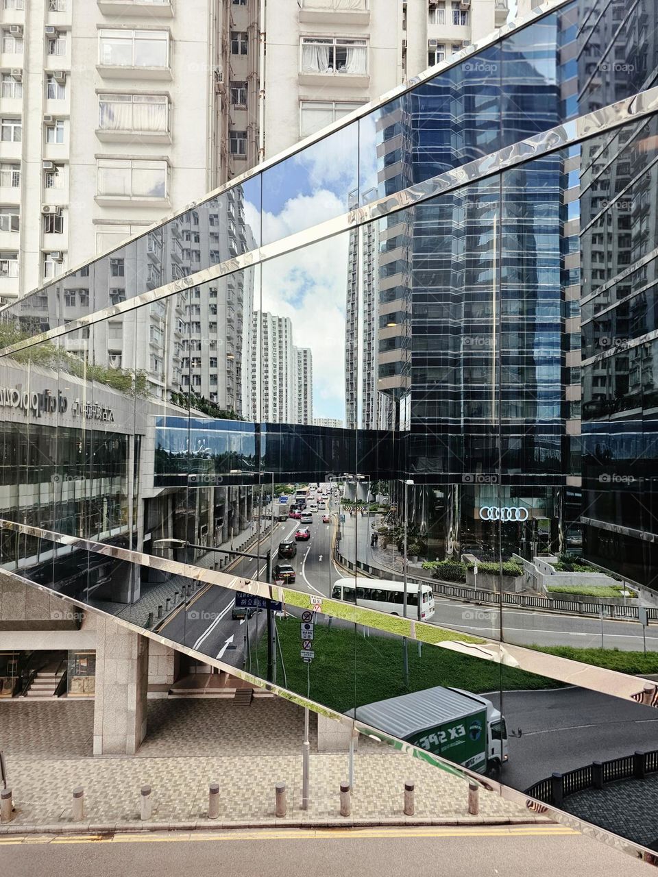 Multiple reflections of footbridge and buildings