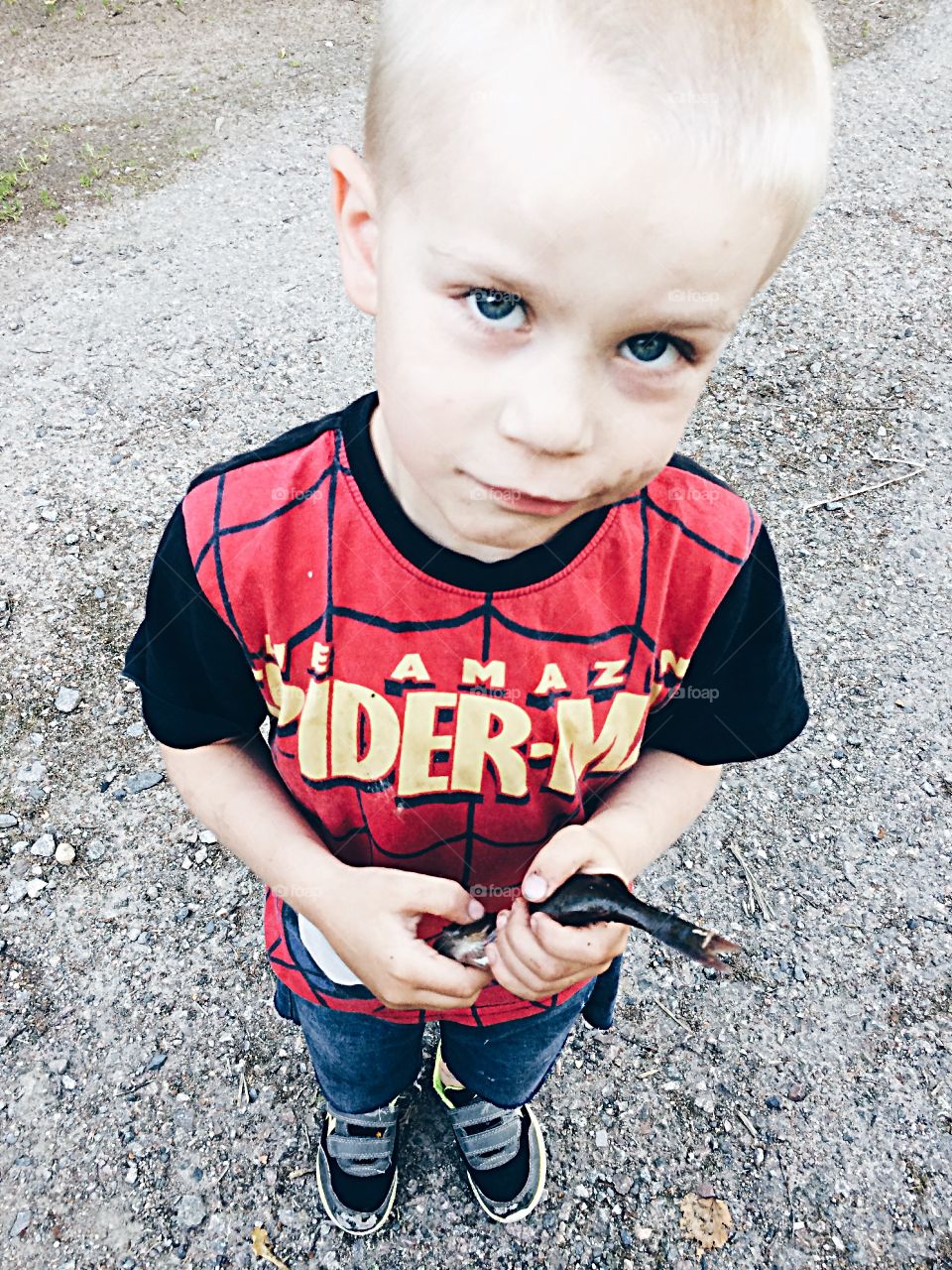 Boy with a fish. Boy holding a fish in his hands 