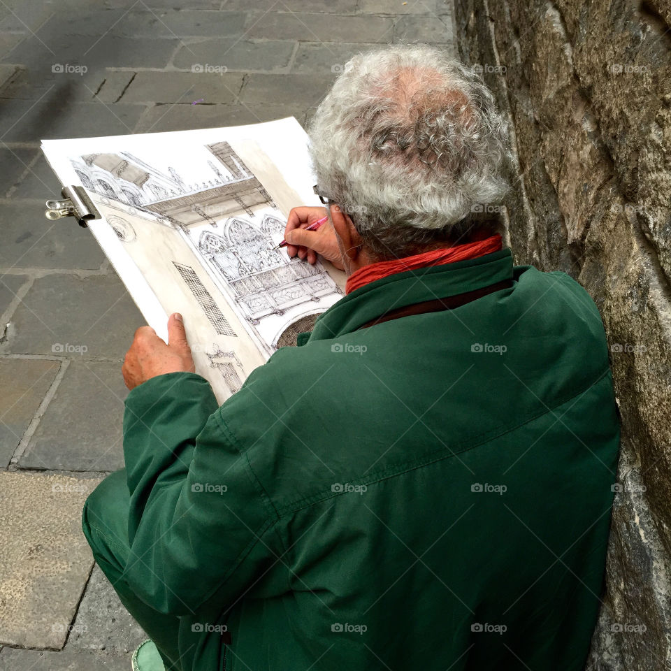 Elderly man drawing the painting 