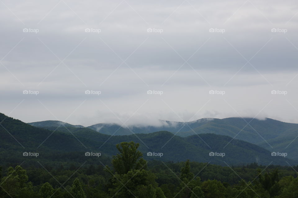 Clouds over mountaintops 