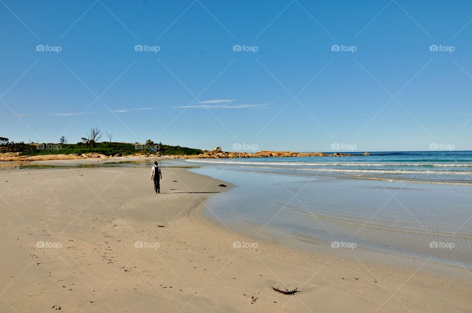Walking along one of Tasmania's beautiful beaches