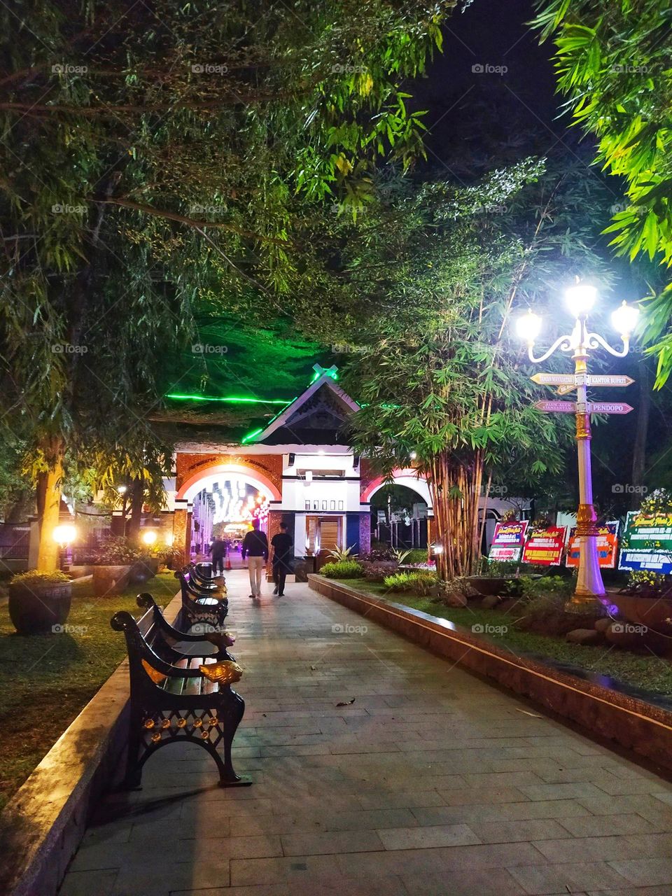 Purwakarta, Indonesia - July 23, 2022: beautiful night view of a city park of Purwakarta, lots of lights, trees and places to sit around