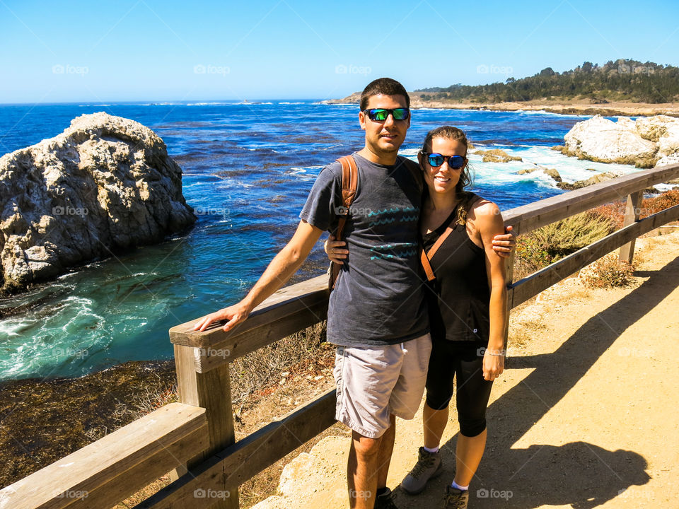 Couple on a beach hike along the California coast. 