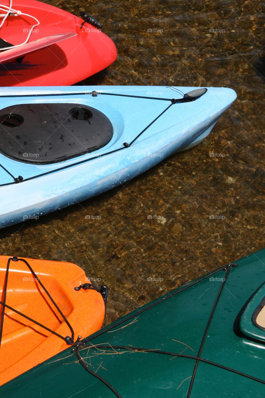 Colorful Kayaks in Shallow Water.