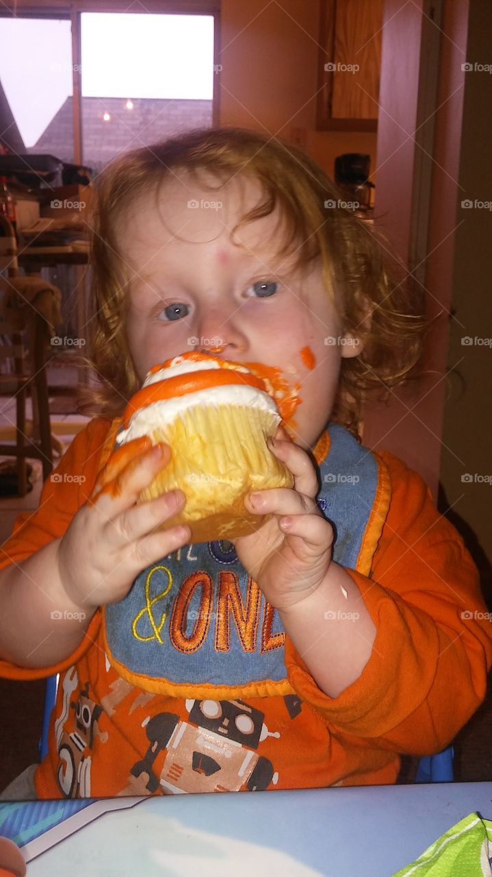 Eating and orange cupcake