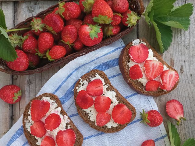fresh strawberries in a basket and a strawberry sandwich.