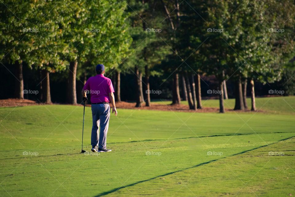A golfer standing at the tee box waiting to hit