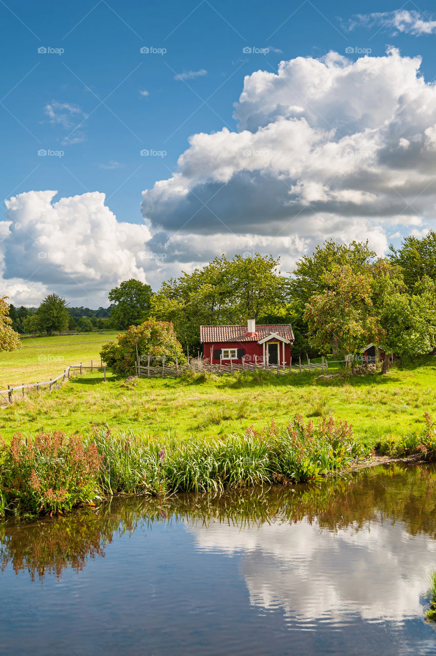 Little red wooden summer house in the fields.