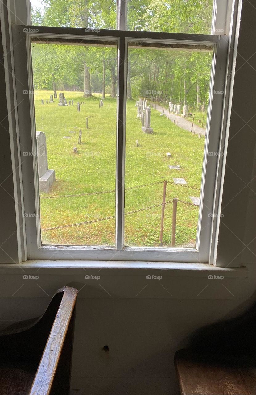 Cemetery through an old church window 