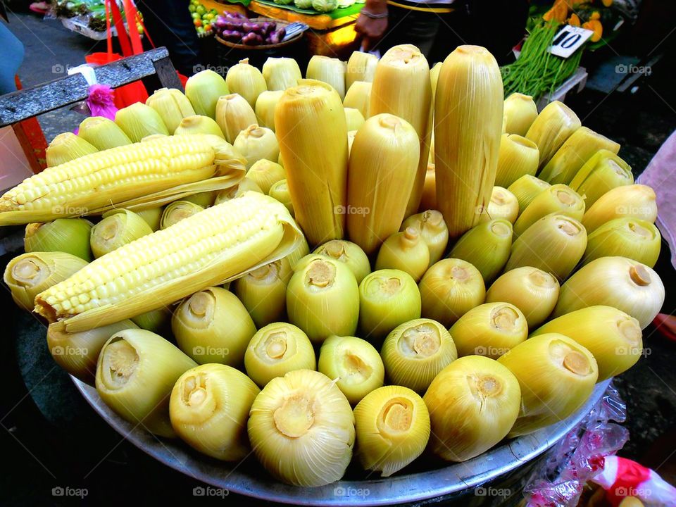 steamed corn on a cob sold by a street vendor