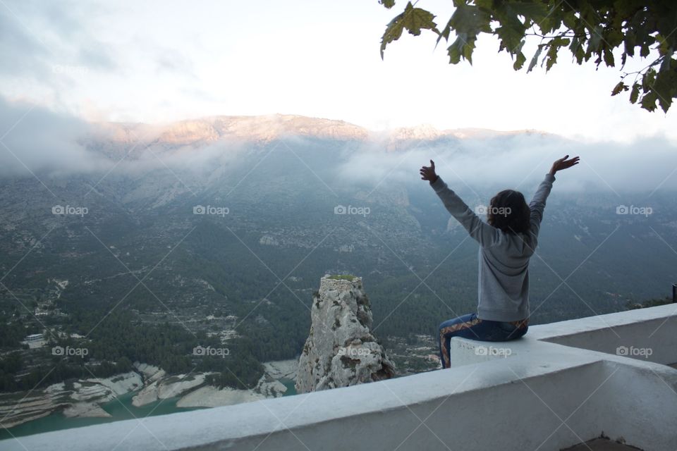 Brunette high above the masterpiece nature. Spain, Guadalest 