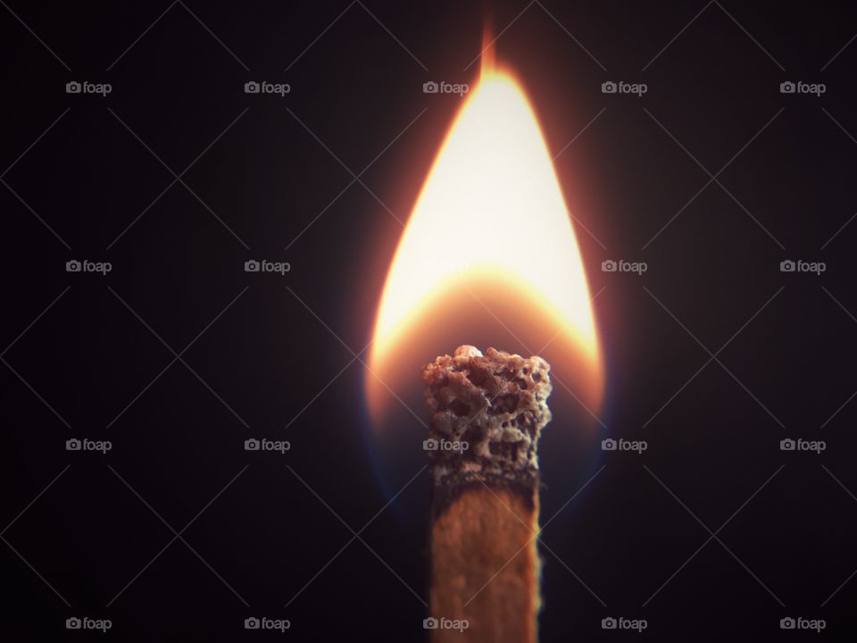 Close-up of burning matchstick