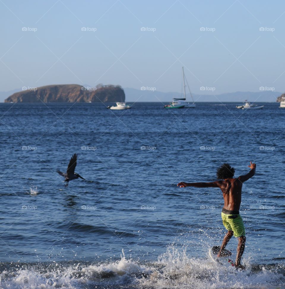 Surfer & pelican