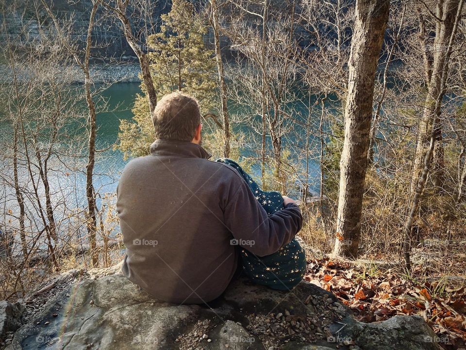 A father and daughter enjoying the peaceful winter view