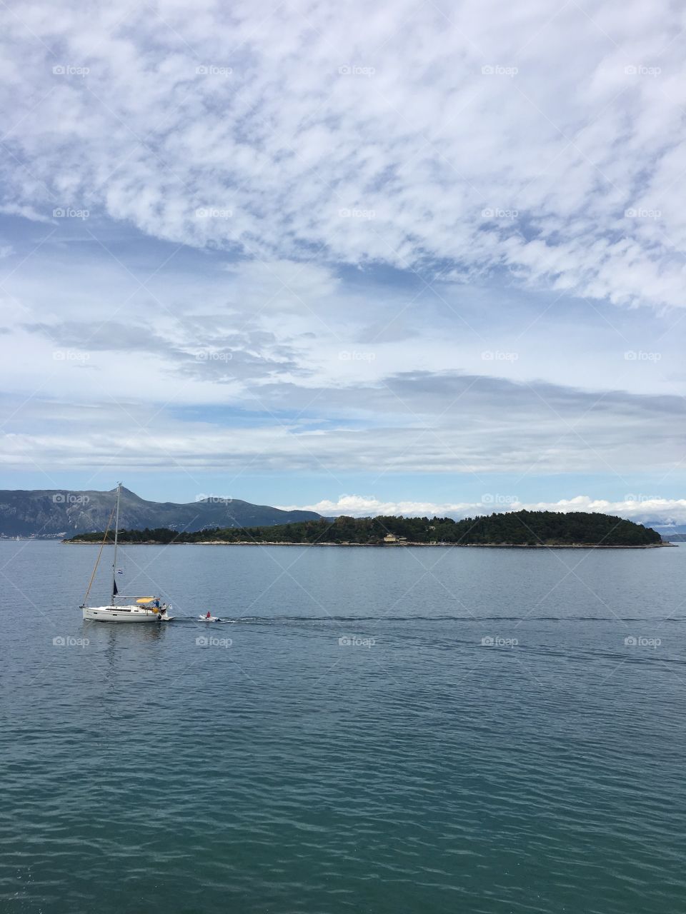 Boat passing Vidos island, Corfu Town, Greece 