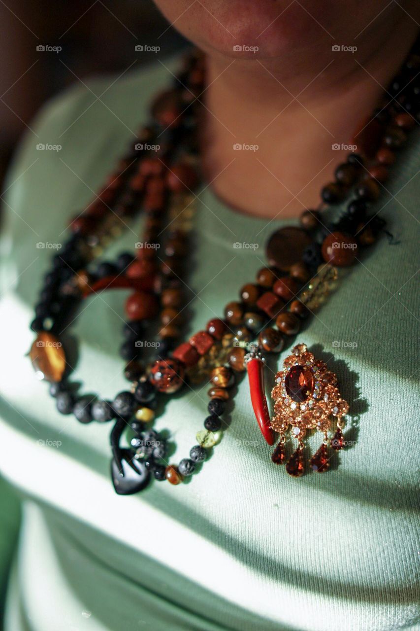 Tiger's eye, volcanic stone necklace and opal brooch