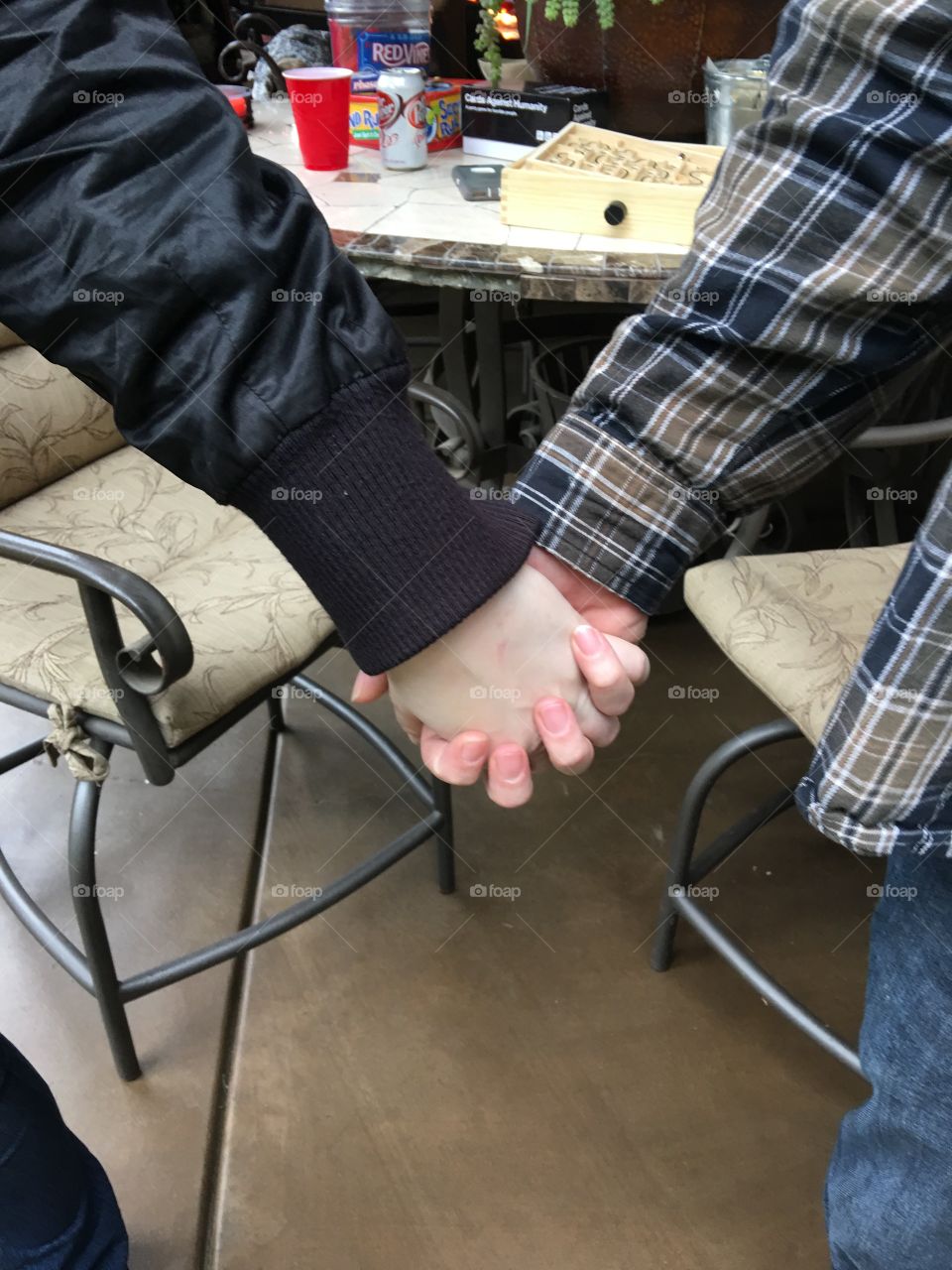 Hands held at a party 