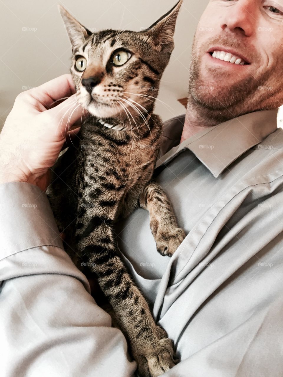 Happy man carrying cat