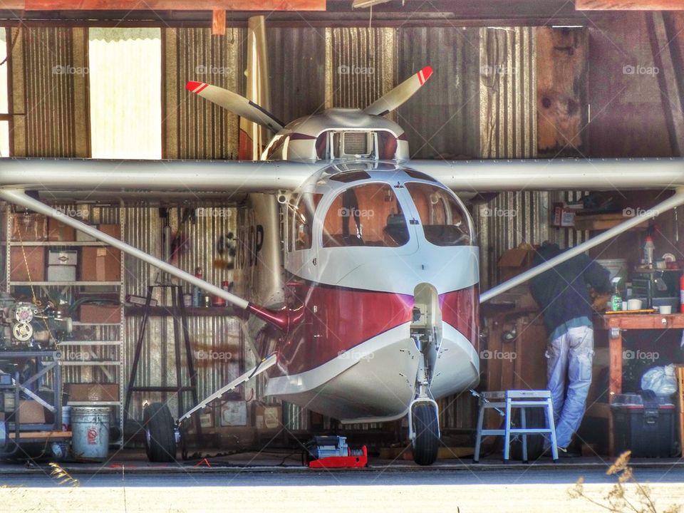 Seaplane In A Hangar. Seaplane And Pilot In The Hangar
