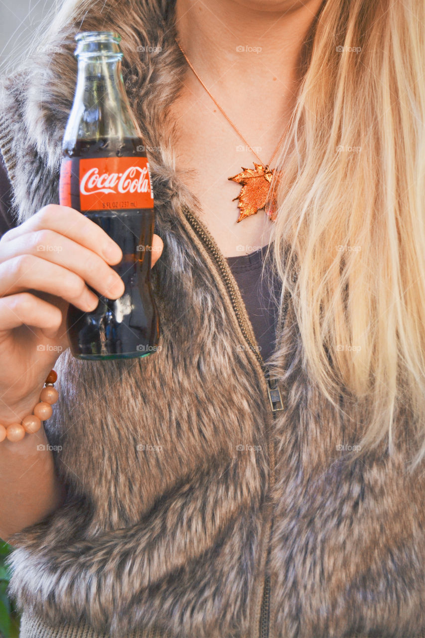 Woman holding bottle of coke 